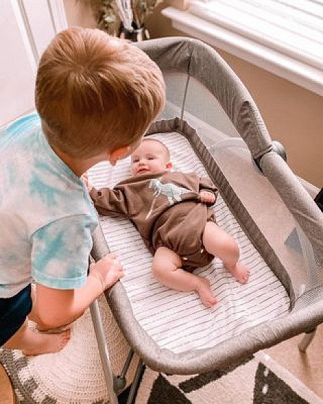 The First Years&trade; First Dreams Portable Bassinet Baby Sleeper in Grey. View a larger version of this product image.