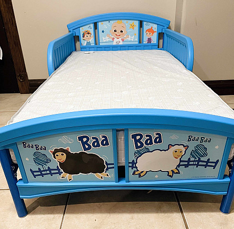 Delta Children CoComelon Plastic Convertible Toddler Bed in Blue. View a larger version of this product image.